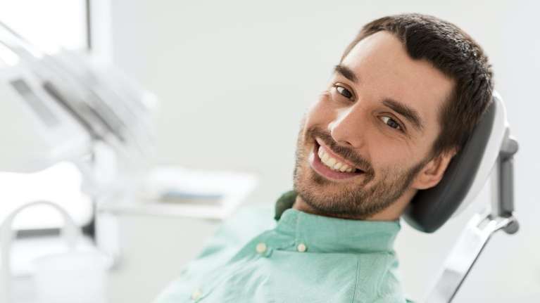 Man smiling after teeth whitening treatment in Rehoboth Beach DE