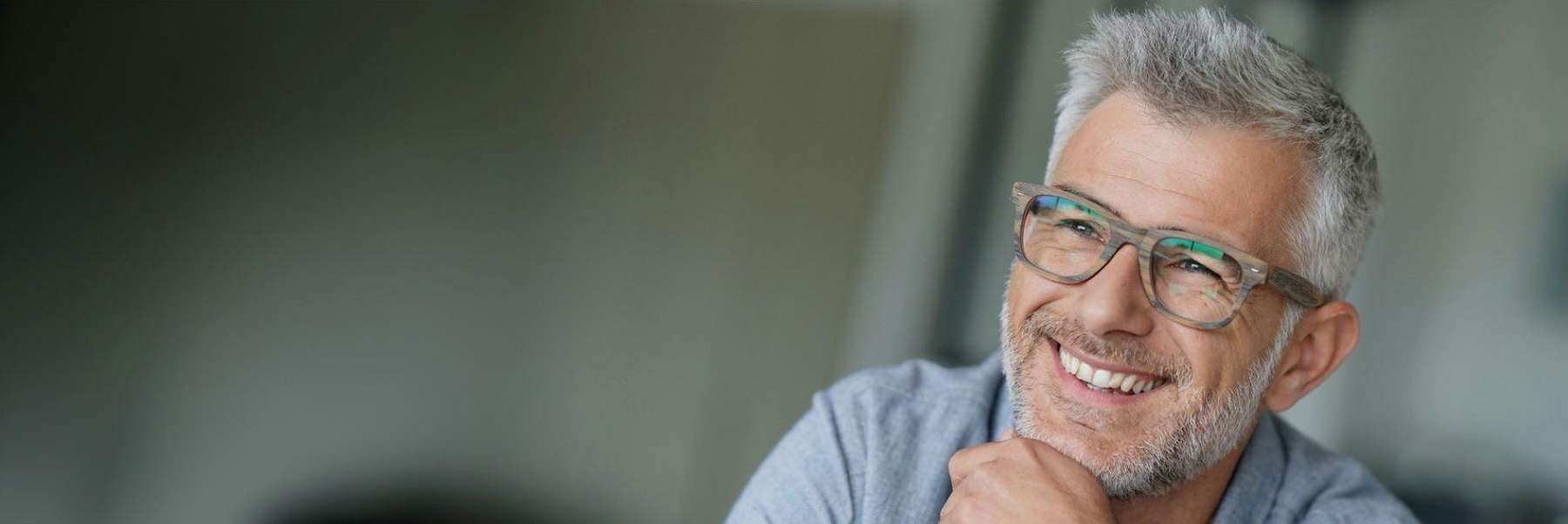 man with glasses confidently smiling | denture solutions Rehoboth Beach DE