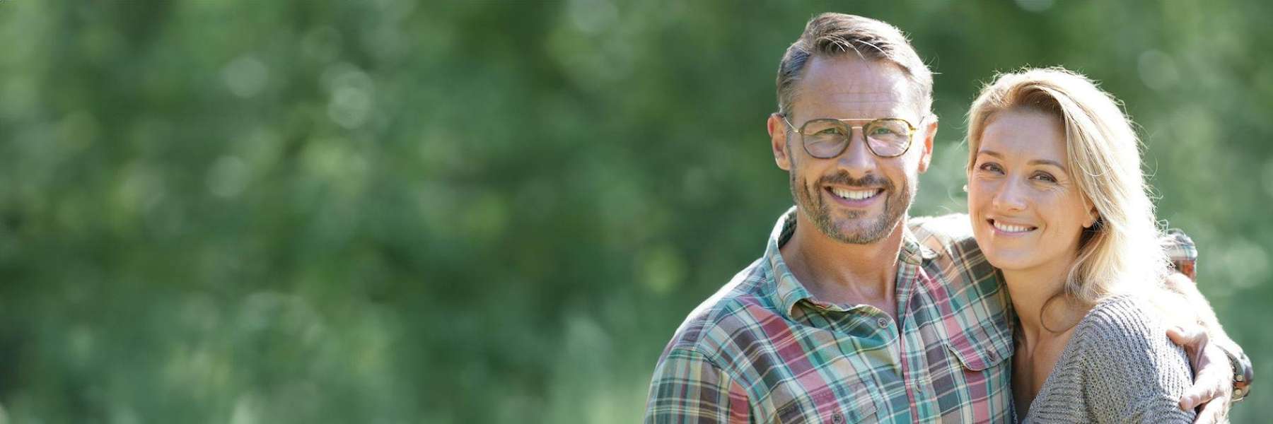 happy couple outdoors after having implant restoration Rehoboth Beach DE 